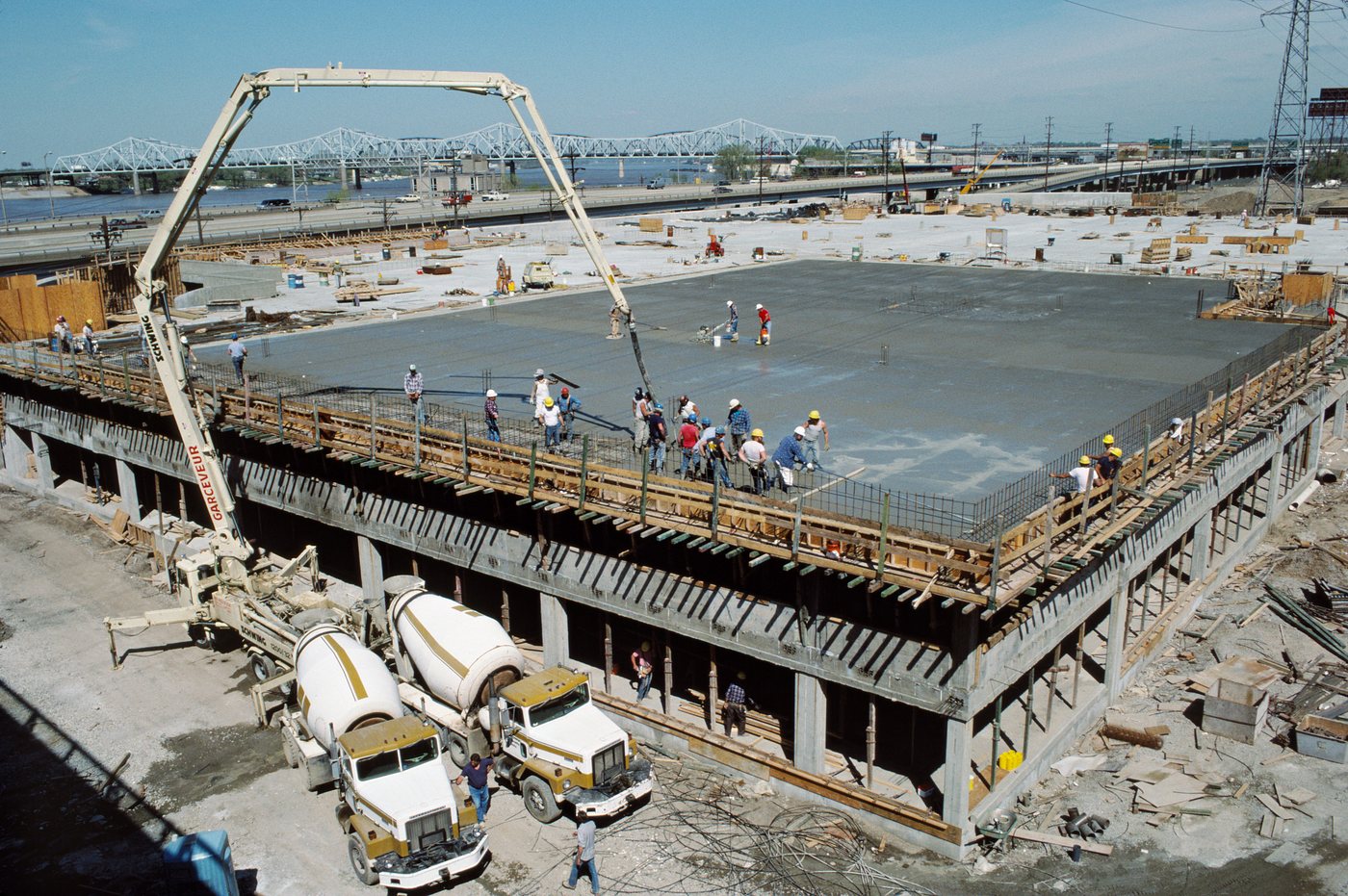 Concrete crew screeding a freshly poured slab
